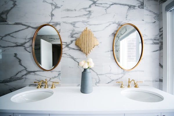 Marble bathroom with double sinks — commercial plumbing for small business in Toronto